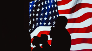 people standing in front of flag